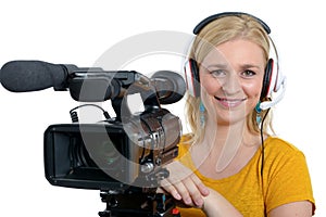 Blond young woman with professional video camcorder, on white