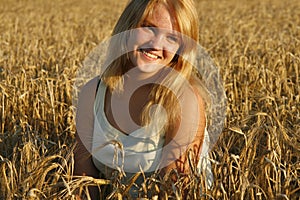 Blond young woman smiling sweetly.