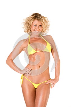 blond young woman in yellow skimpy bikini