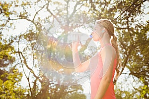 Blonde athlete drinking water out of bottle