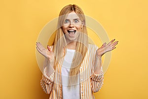 Blonde awesome excited astonished woman with opened mouth screaming