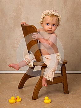 Blonde baby on vintage chair