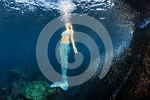 Blonde beautiful Mermaid diver underwater