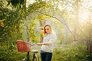 Blonde beautiful woman on a vintage bicycle