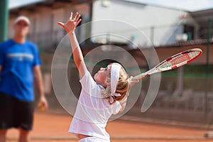 Blonde boy practicing tennis