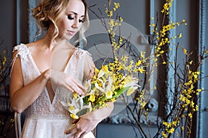 Blonde bride in fashion white wedding dress with makeup