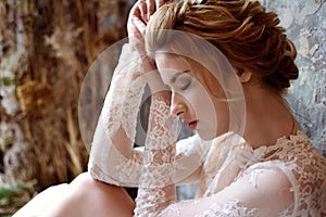 Blonde bride in fashion white wedding dress with makeup