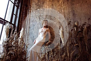 Blonde bride in fashion white wedding dress with makeup