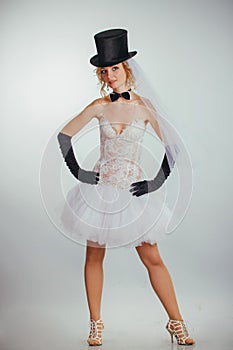 Blonde bride in tophat with veil and long black gloves