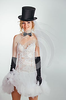 Blonde bride in tophat with veil and long black gloves