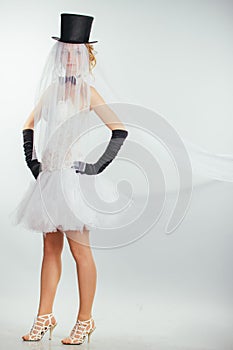 Blonde bride in tophat with veil and long black gloves