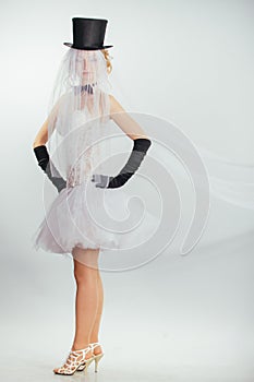 Blonde bride in tophat with veil and long black gloves