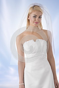 Blonde bride with veil in front of the camera