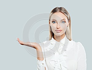 Blonde business woman showing empty open hand
