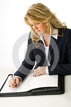 Blonde business woman taking notes