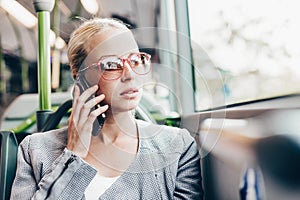 Blonde business woman traveling by bus.