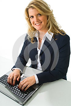 Blonde business woman working on computer