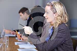 Blonde businesswoman sitting at conference table