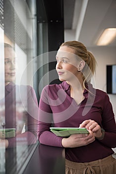 Blonde businesswoman working on tablet at office