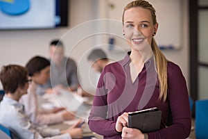 Blonde businesswoman working on tablet at office