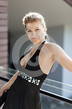 Blonde caucasian woman in black dress