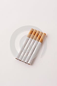 blonde cigarettes with filter on a white table, white background