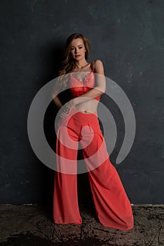 Blonde in coral bustier and slacks
