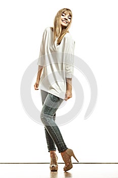 Blonde fashion woman in white shirt denim pants