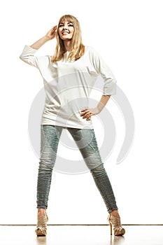 Blonde fashion woman in white shirt denim pants