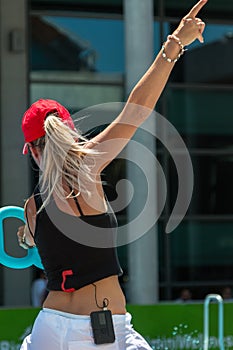 Blonde Female Instructor with Red Hat Teaching Aqua Aerobics at