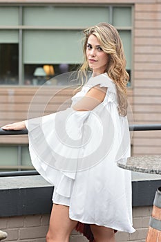 Blonde Female Model Posing by a Railing