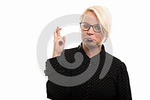 Blonde female teacher wearing glasses showing cross finger gestu