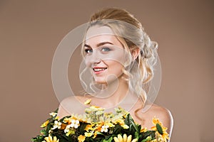 Blonde with flowers in their hands