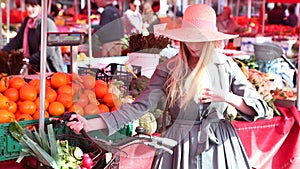 Blonde girl with bike standing at the market