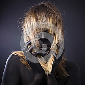 Blonde girl with black bodypainting.