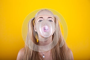 Blonde girl blows up bubble gum