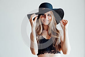 Blonde girl with blue eyes a hat with a brim on a white background