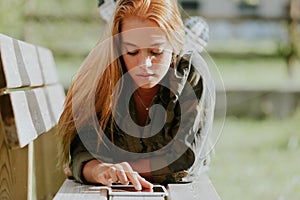 Blonde girl, casual-sporty attire, digital tablet photo