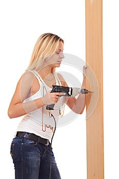 Blonde girl drilling the wall