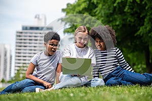 Blonde girl helping teens with their project work