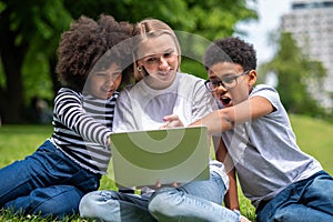Blonde girl helping teens with their project work