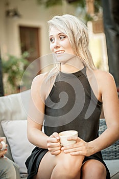Blonde girl holding a coffee cup