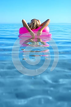 Blonde girl on inflatable raft