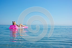 Blonde girl on inflatable raft