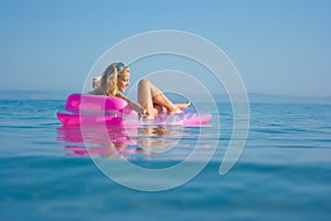 Blonde girl on inflatable raft