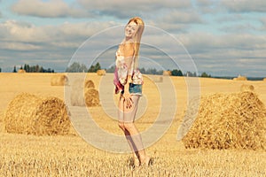 Blonde girl jumps in sloping field