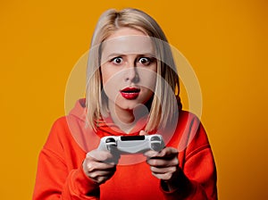 Blonde girl keen plays with a joystick
