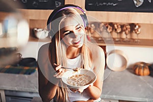 Blonde Girl Listening Music And Eating Breakfast