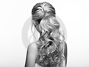 Blonde girl with long and shiny curly hair