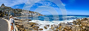 A girl looking at a view of robyns bay in cape town,south africa photo